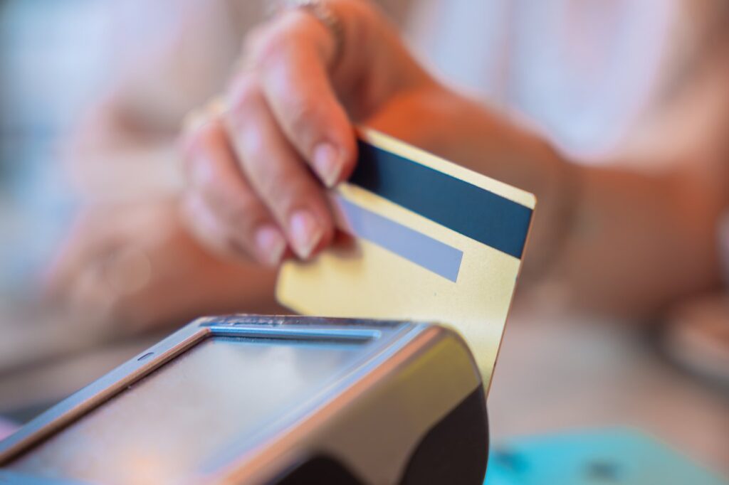 Customer paying with a credit card on a contactless payment terminal